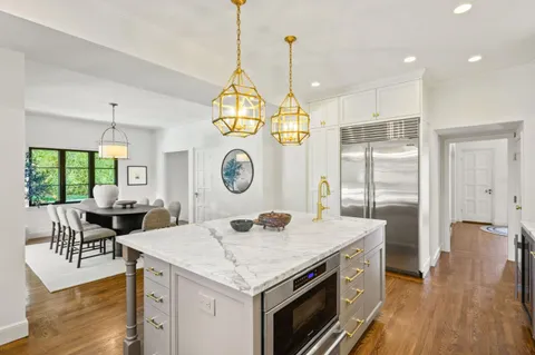 a large kitchen with kitchen island a large island in it