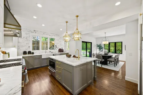 a kitchen with a stove a sink and a microwave