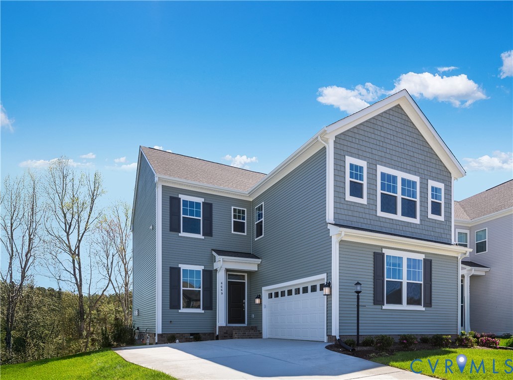 6616 Cassia Loop Moseley, VA 23120 - Photo 1 of 14 a front view of a house with garden