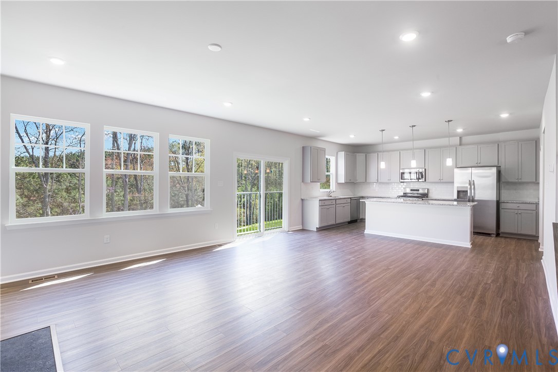 6616 Cassia Loop Moseley, VA 23120 - Photo 2 of 14 a view of kitchen with wooden floor and windows