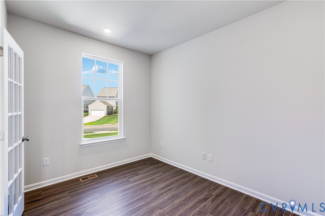 6616 Cassia Loop Moseley, VA 23120 - Photo 7 of 14 an empty room with window and wooden floor