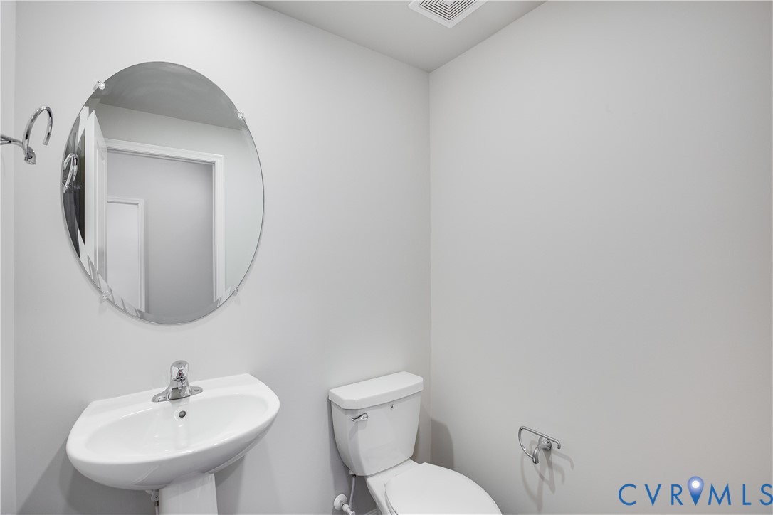 6616 Cassia Loop Moseley, VA 23120 - Photo 8 of 14 a bathroom with a toilet sink and mirror