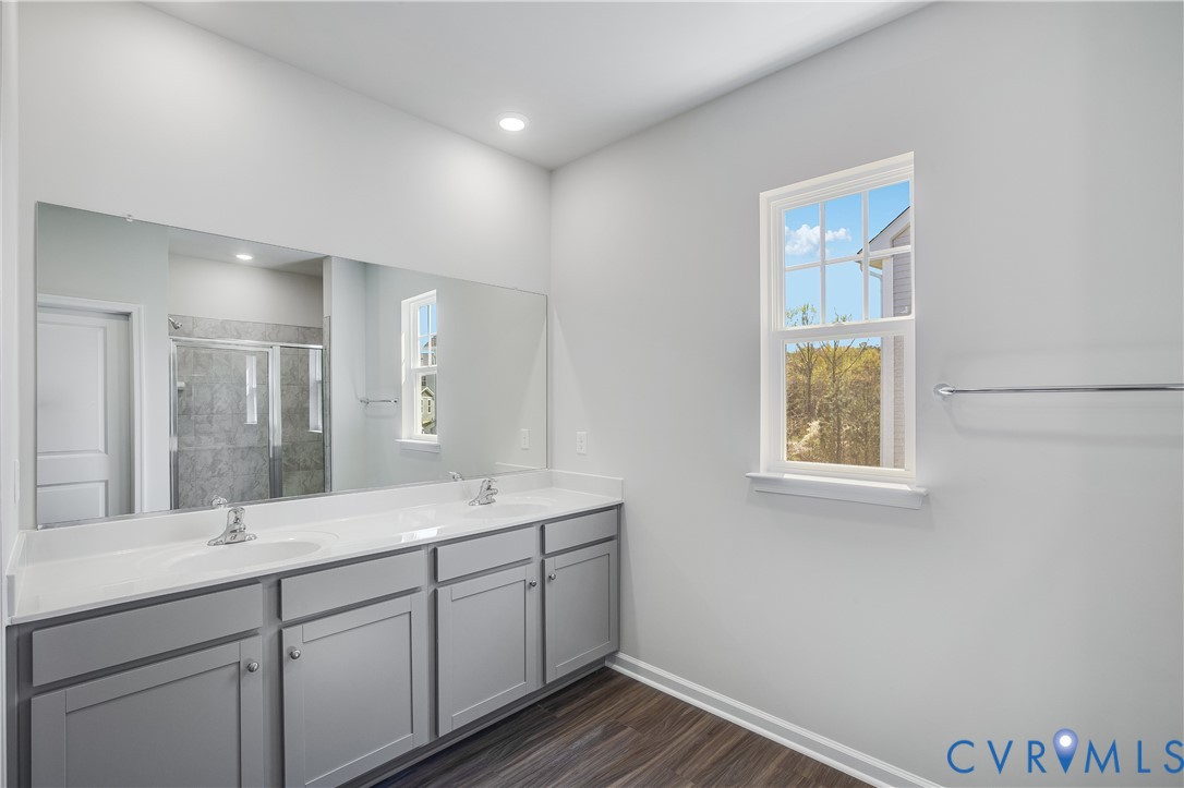6616 Cassia Loop Moseley, VA 23120 - Photo 9 of 14 a bathroom with a double vanity sink and a mirror