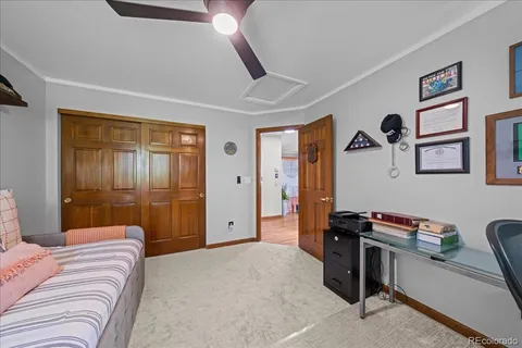 a bedroom with a bed and a desk