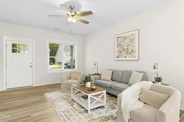 a living room with furniture a table and a window
