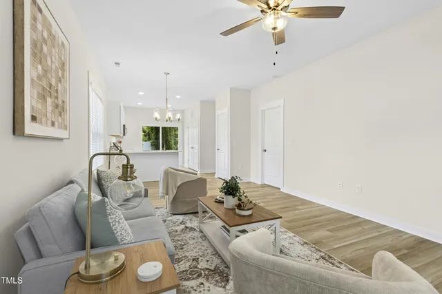 a living room with furniture and a chandelier