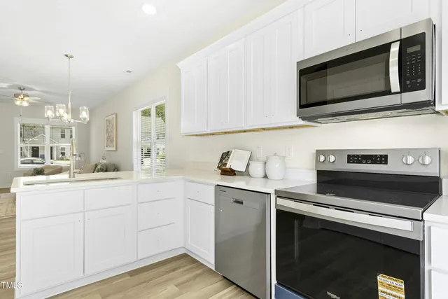 a kitchen with a sink stove and microwave