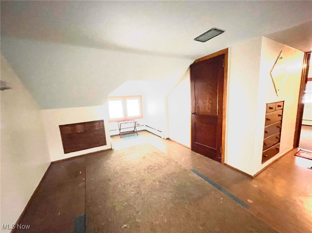 1302 Waverly Road Sandusky, OH 44870 - Photo 7 of 13 Additional living space featuring baseboard heating and lofted ceiling