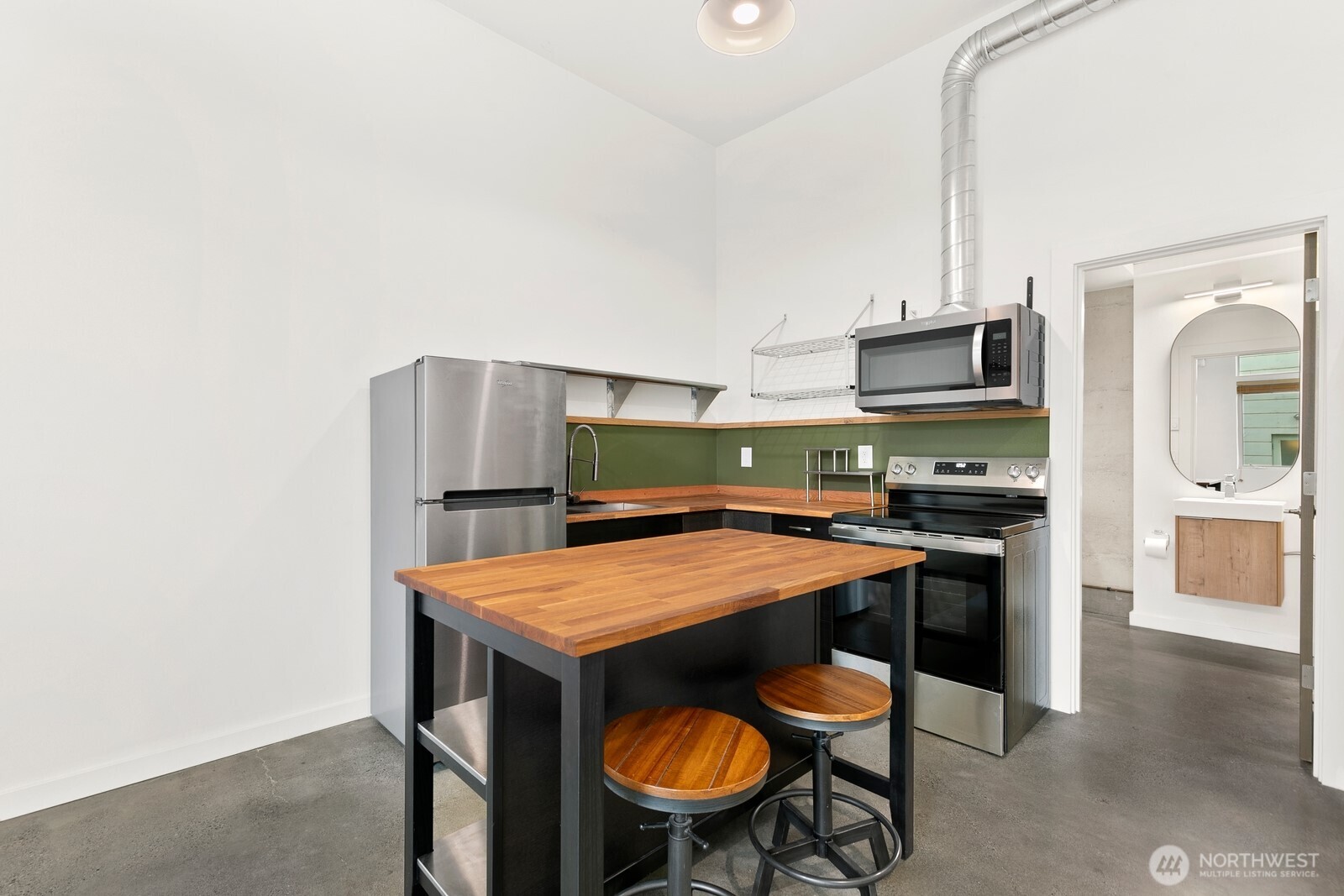 3527 South Oregon Street Seattle, WA 98118 - Photo 16 of 24 a kitchen with stainless steel appliances a table and chairs in it