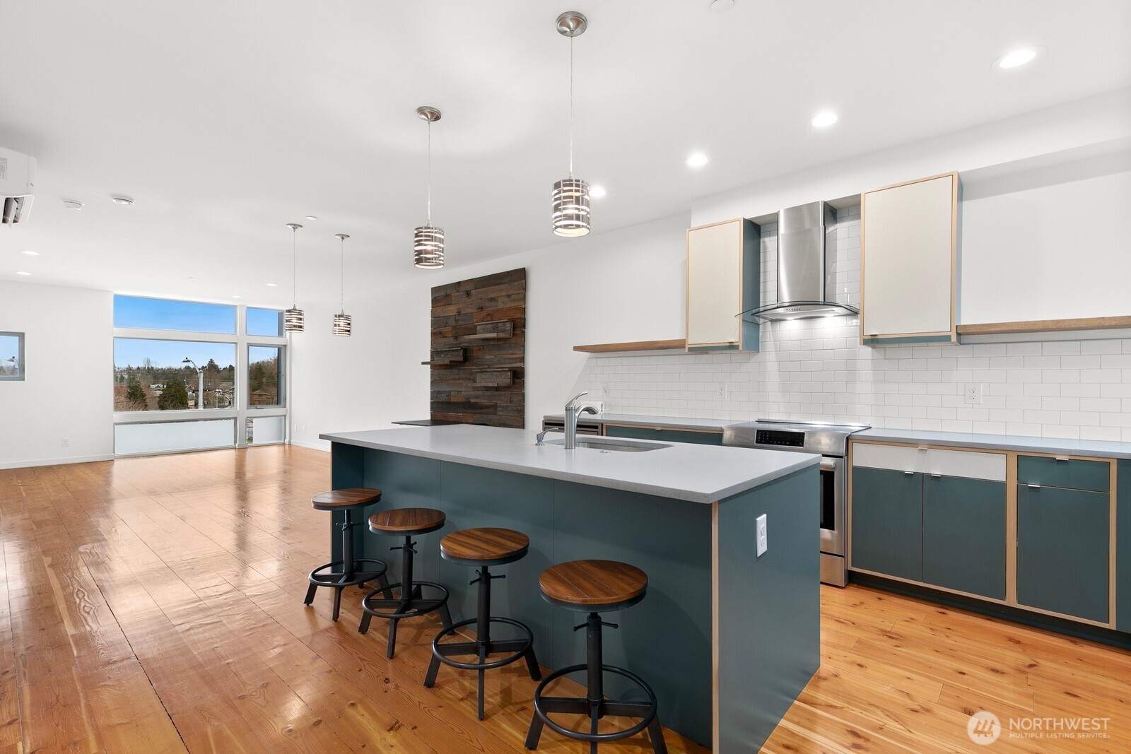 3527 South Oregon Street Seattle, WA 98118 - Photo 3 of 24 a kitchen with stainless steel appliances granite countertop a table chairs sink and cabinets