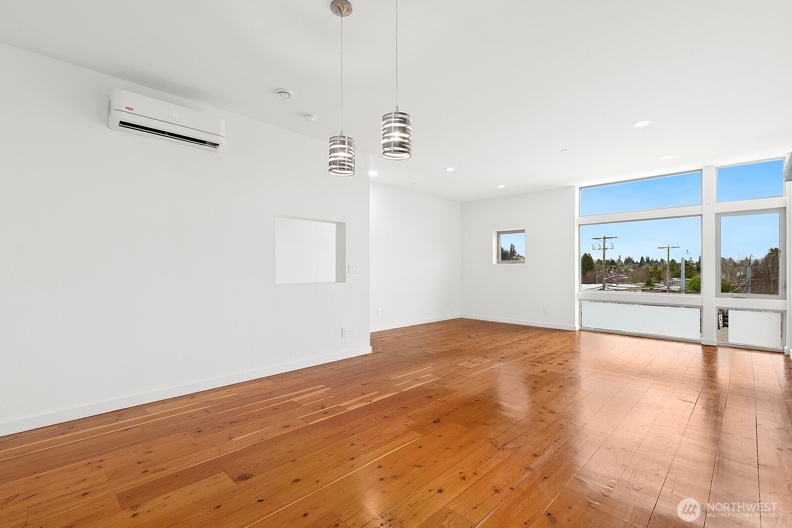 3527 South Oregon Street Seattle, WA 98118 - Photo 6 of 24 a view of an empty room and window with wooden floor