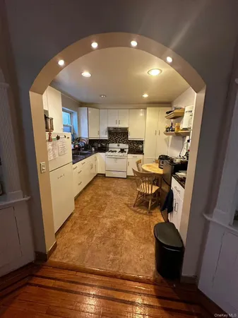 a kitchen with a refrigerator and a stove top oven