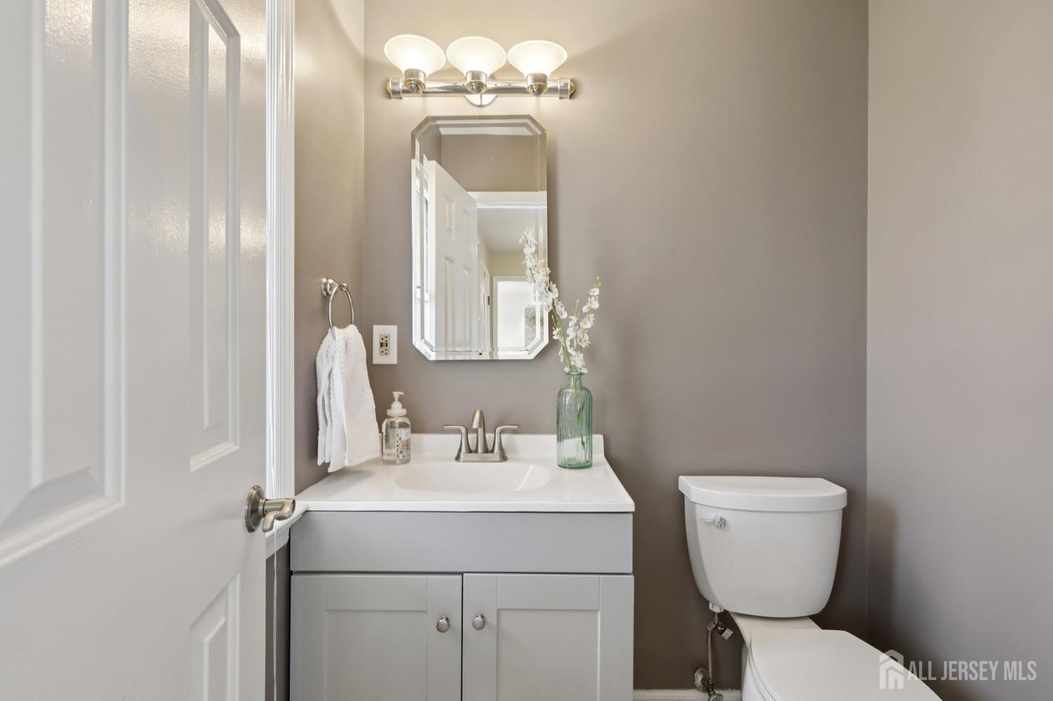 53 Salem Street Edison, NJ 08820 - Photo 16 of 39 a bathroom with a toilet sink and mirror