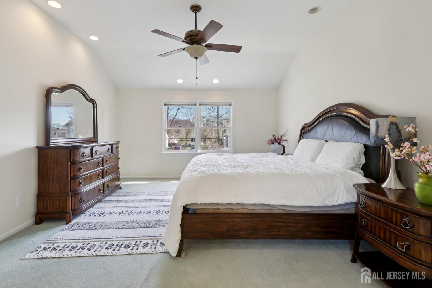 53 Salem Street Edison, NJ 08820 - Photo 17 of 39 a spacious bedroom with a bed a dresser and potted plants