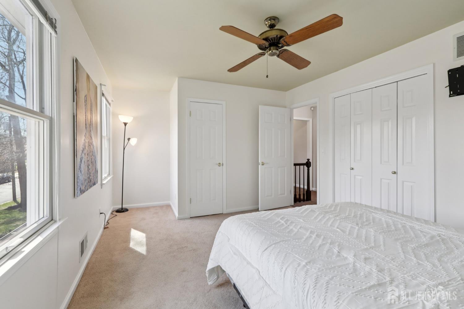 53 Salem Street Edison, NJ 08820 - Photo 21 of 39 a bedroom with a large bed and a chandelier fan