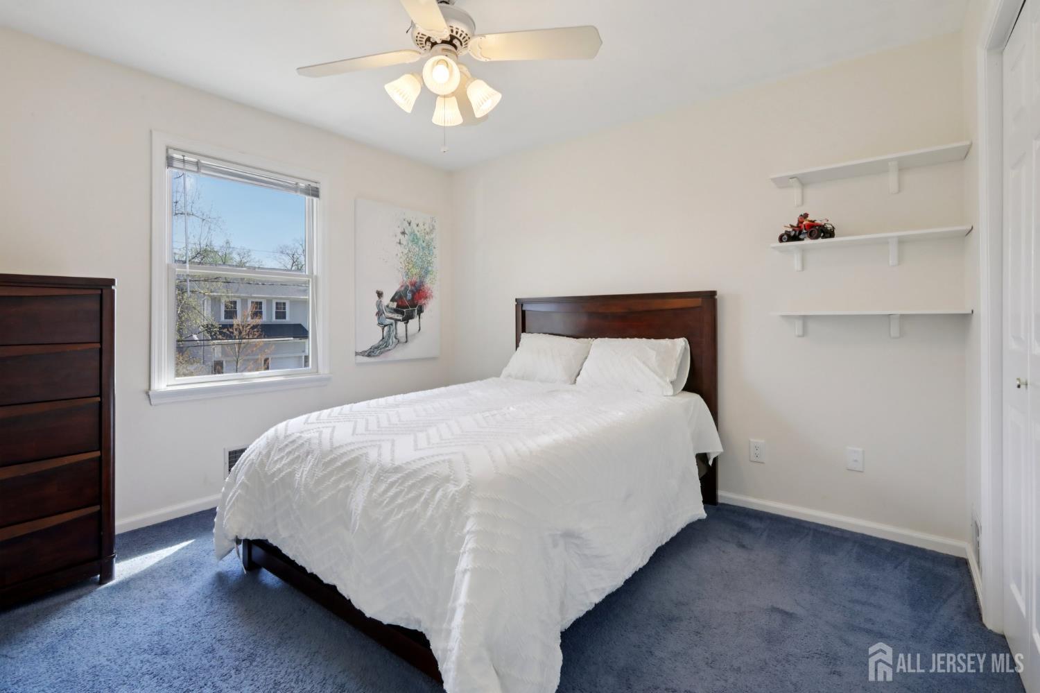 53 Salem Street Edison, NJ 08820 - Photo 22 of 39 a bedroom with a bed and a chandelier