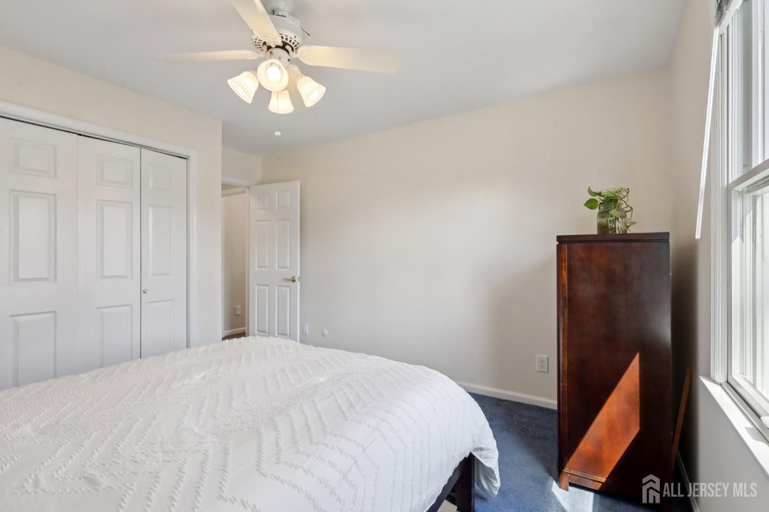 53 Salem Street Edison, NJ 08820 - Photo 23 of 39 a bedroom with a bed and a flat tv screen on a dresser