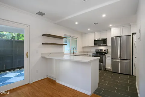 a kitchen with a refrigerator a sink and a counter top space