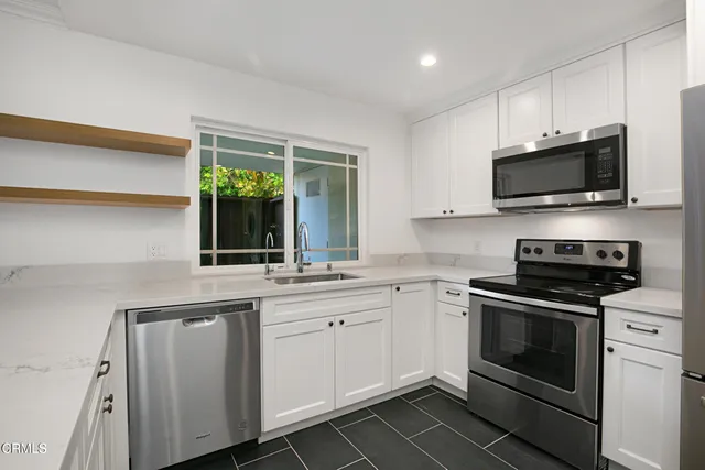 a kitchen with a sink stove and microwave