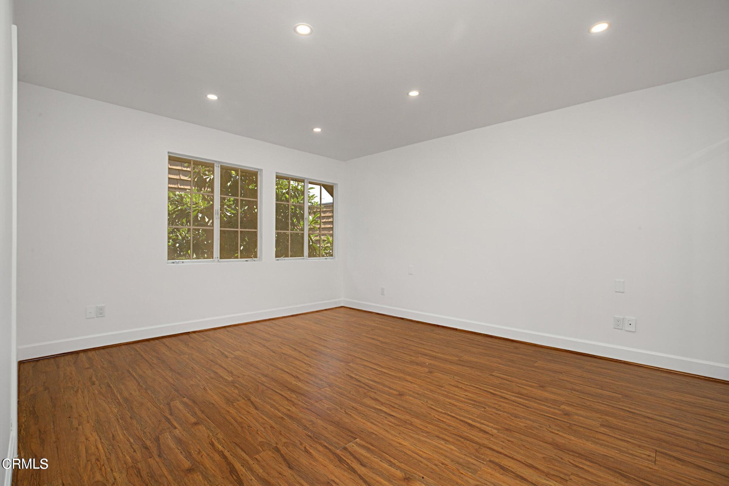 1429 Valley View Road, Unit 13 Glendale, CA 91202 - Photo 16 of 29 an empty room with wooden floor and windows
