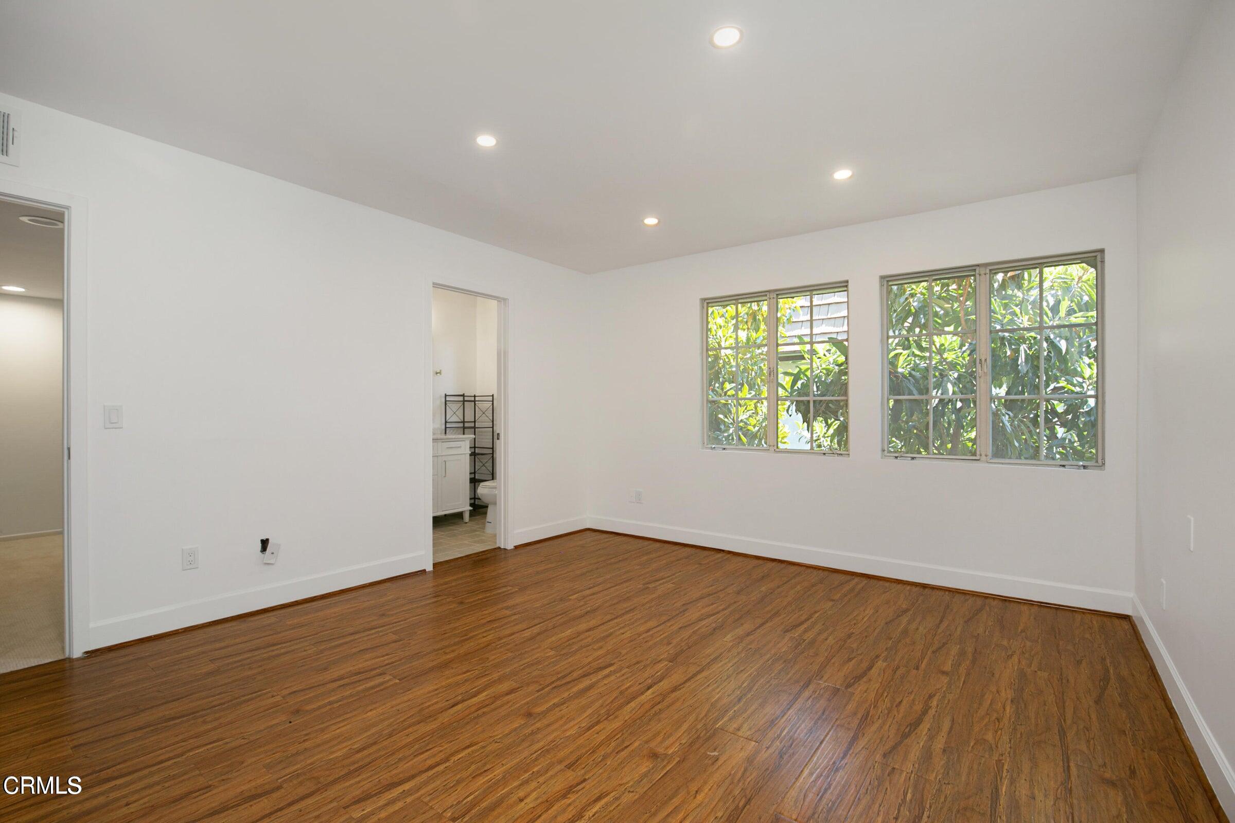 1429 Valley View Road, Unit 13 Glendale, CA 91202 - Photo 17 of 29 an empty room with wooden floor and windows