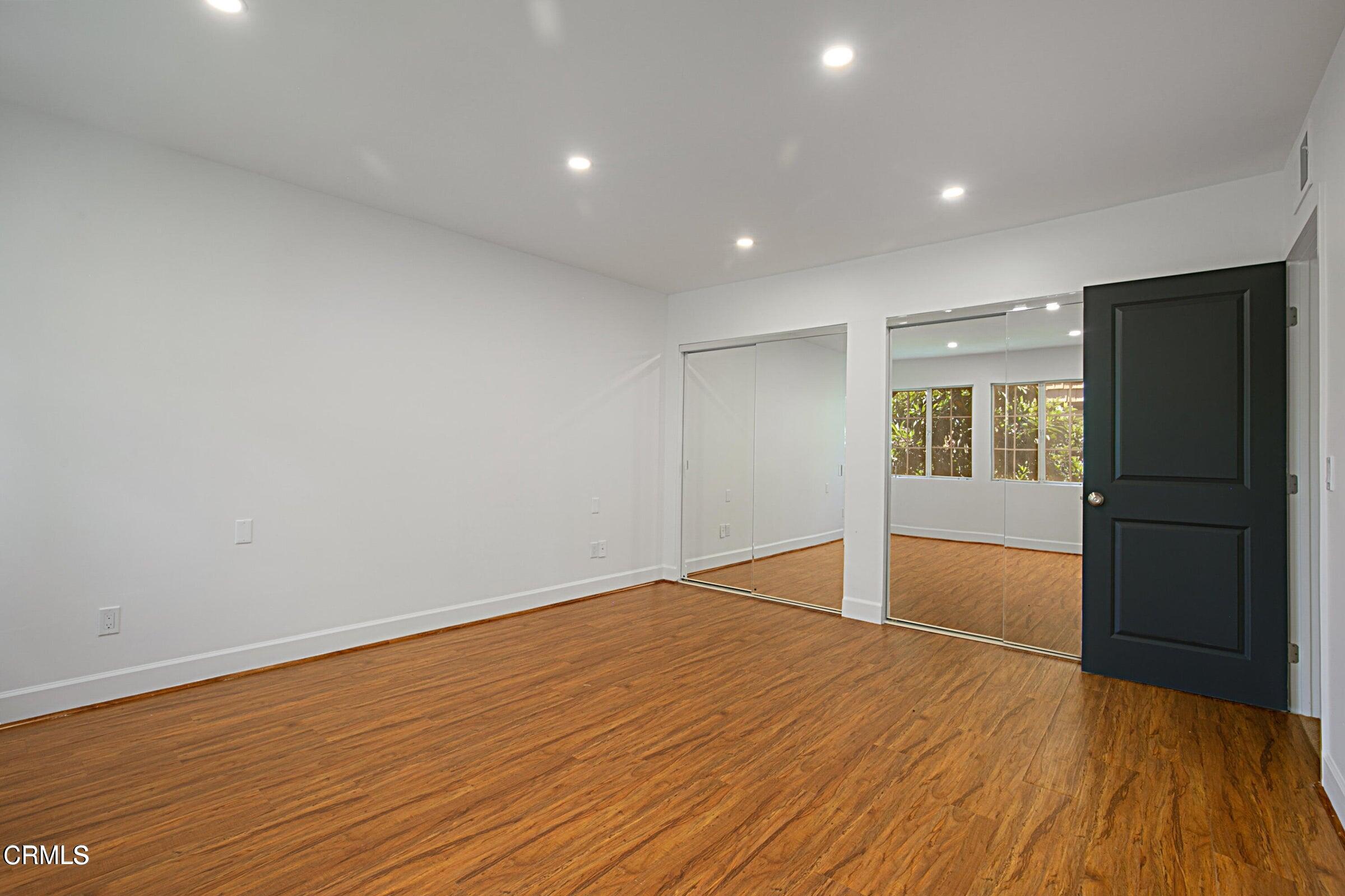 1429 Valley View Road, Unit 13 Glendale, CA 91202 - Photo 18 of 29 a view of an empty room with wooden floor and a window