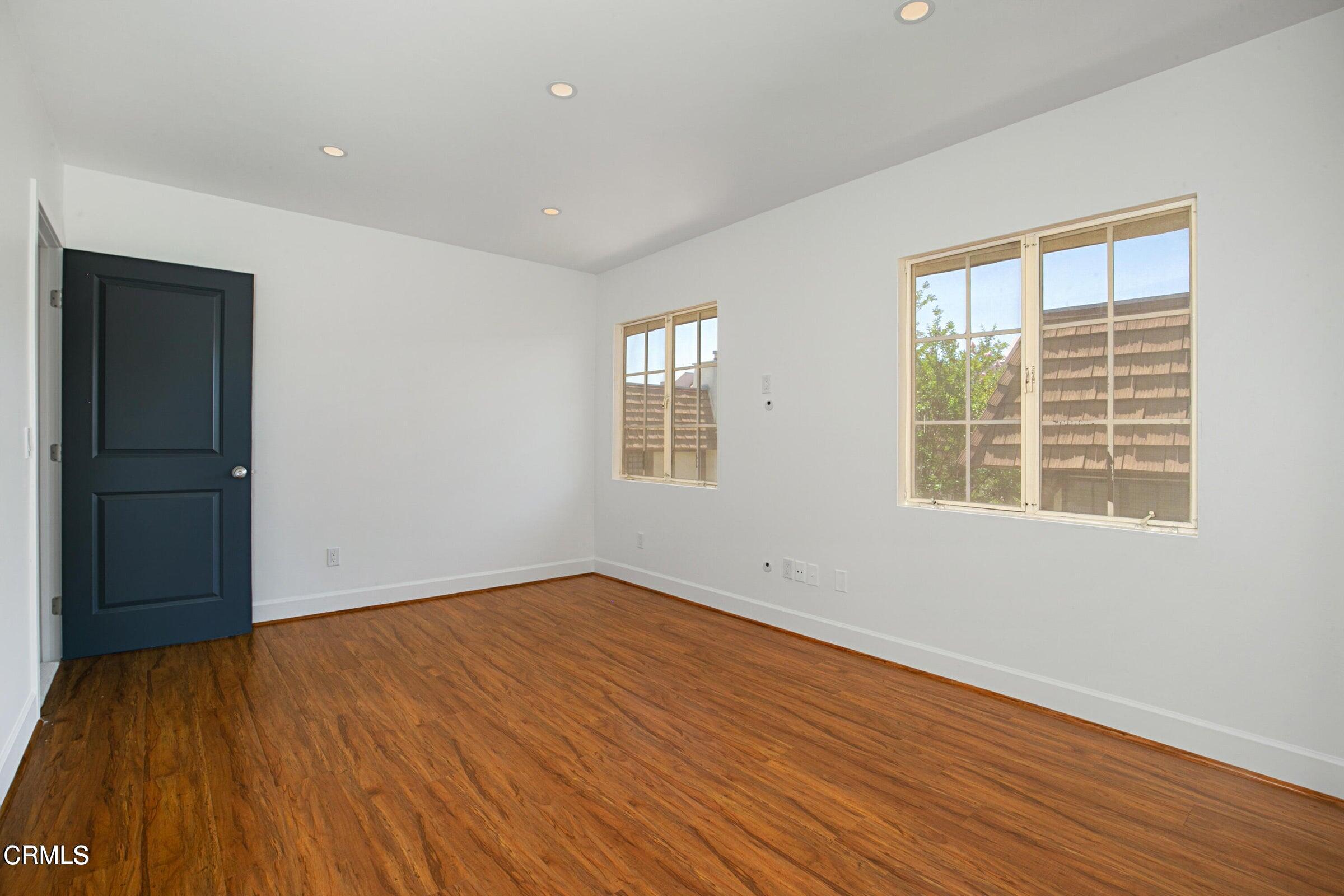1429 Valley View Road, Unit 13 Glendale, CA 91202 - Photo 22 of 29 a view of an empty room with wooden floor and a window