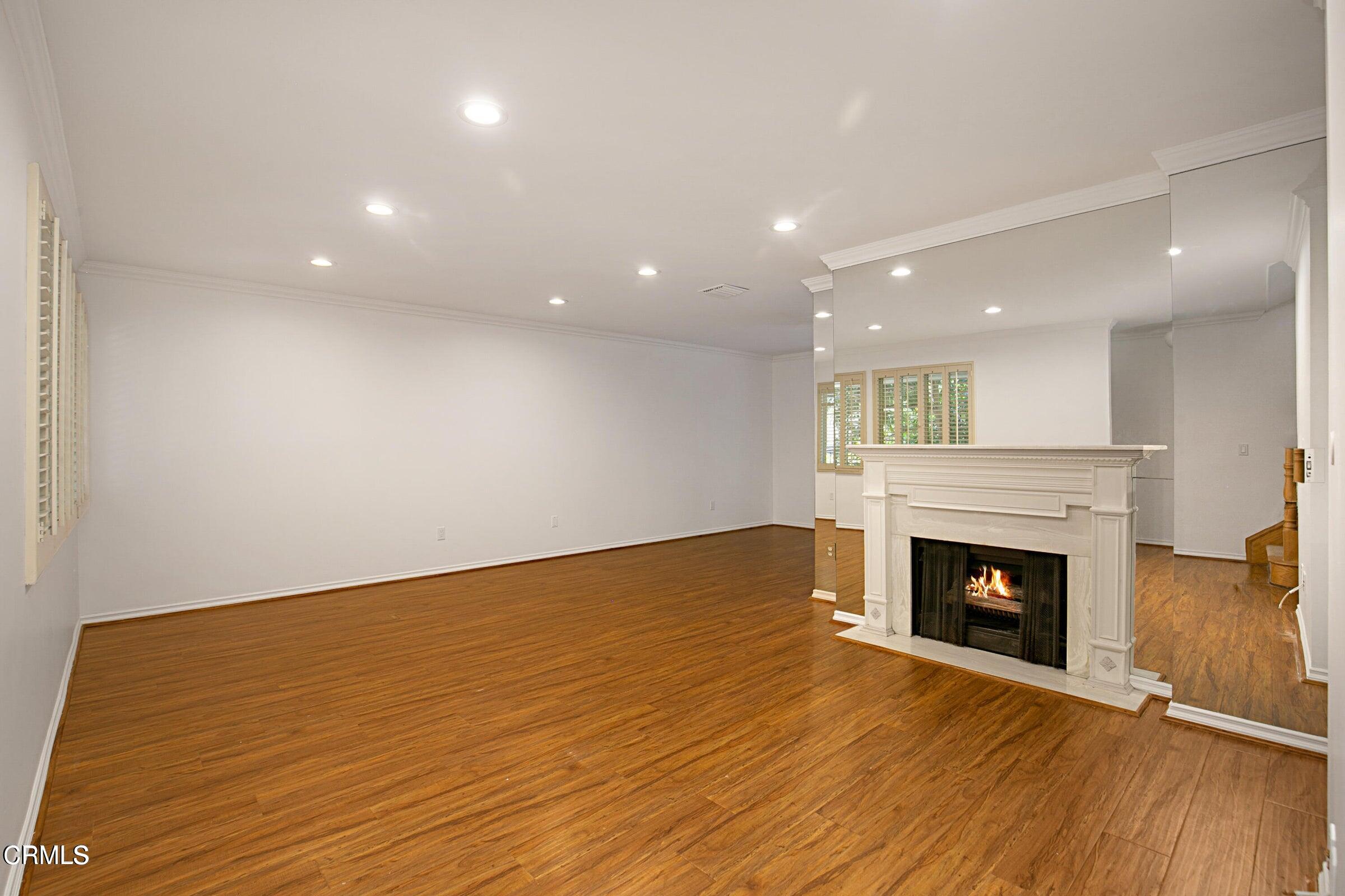 1429 Valley View Road, Unit 13 Glendale, CA 91202 - Photo 7 of 29 a view of an empty room with wooden floor and a fireplace