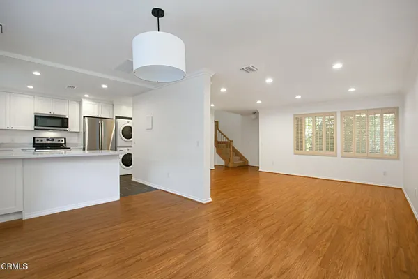 a view of kitchen with sink and wooden floor
