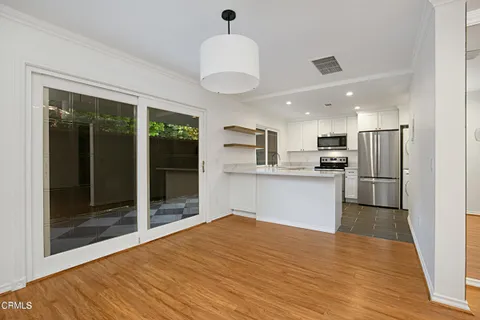 a kitchen with stainless steel appliances granite countertop a refrigerator and a sink