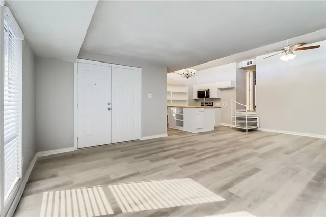 a view of a livingroom with wooden floor and a fireplace