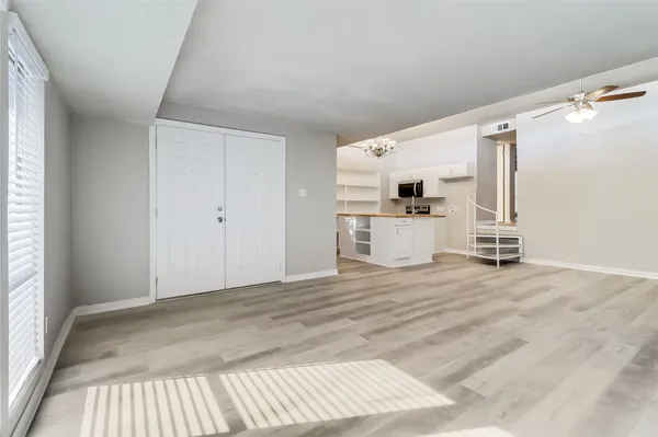 a view of a livingroom with wooden floor and a fireplace