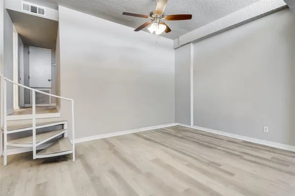 an empty room with a empty space and a ceiling fan