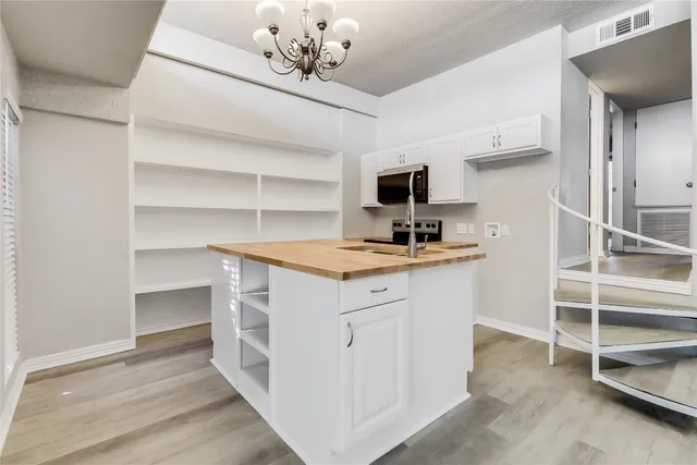 a view with cabinets and wooden floor