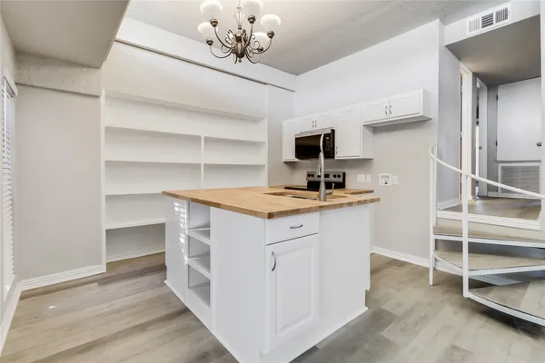 a view with cabinets and wooden floor
