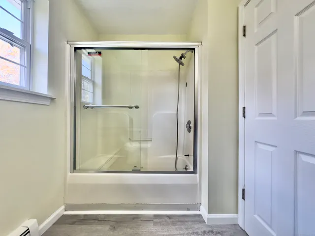 a bathroom with a glass shower door