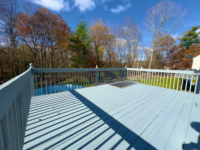 a wooden deck with sunset view