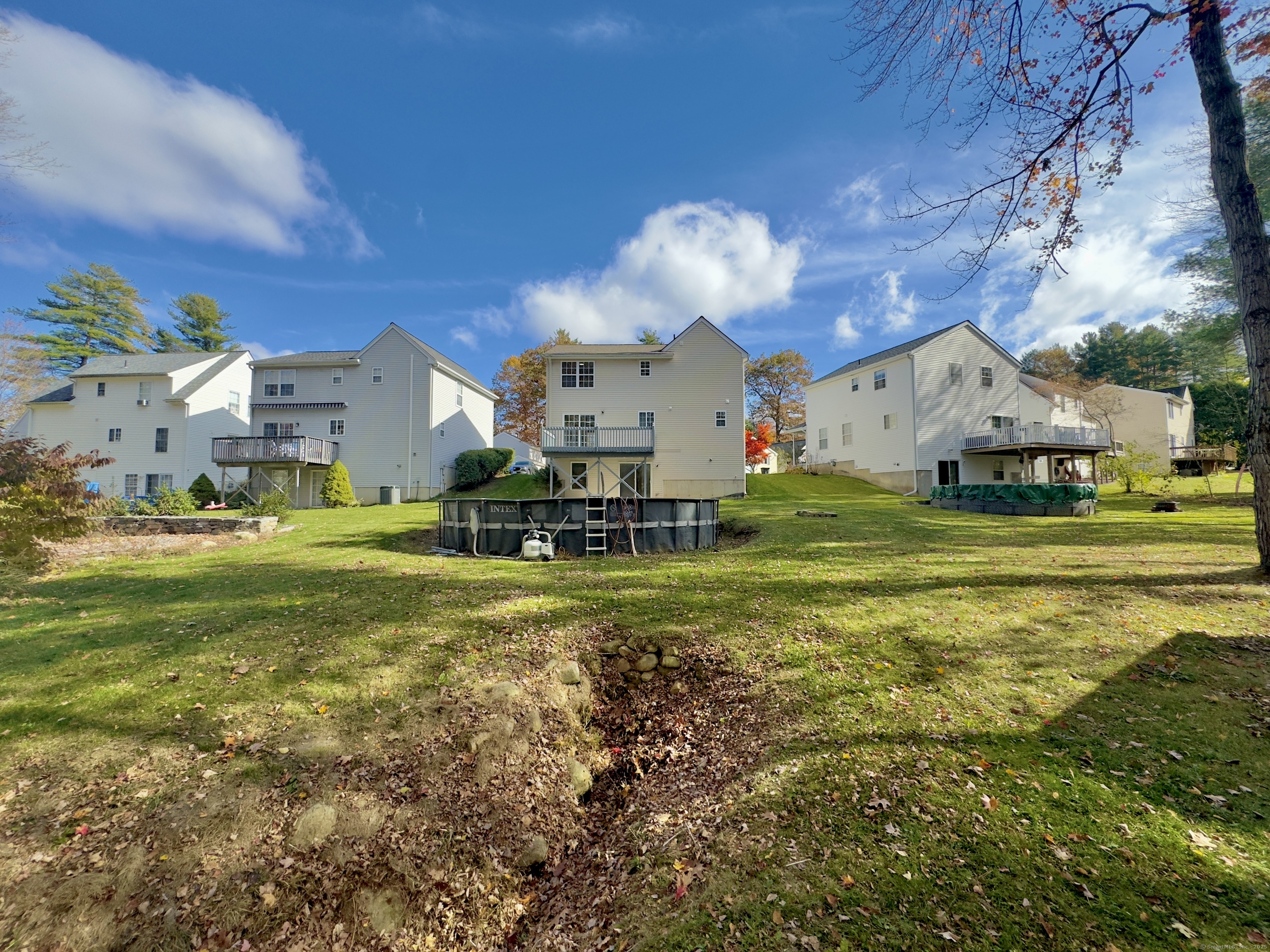 109 Winterberry Way Torrington, CT 06790 - Photo 17 of 22 a view of a house with a big yard and large trees
