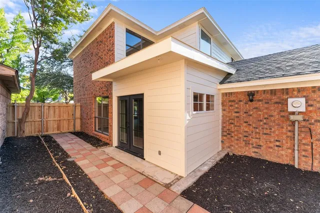 a view of a house with wooden fence