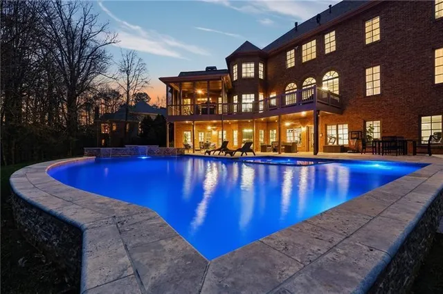 a view of a swimming pool with an outdoor space and seating area