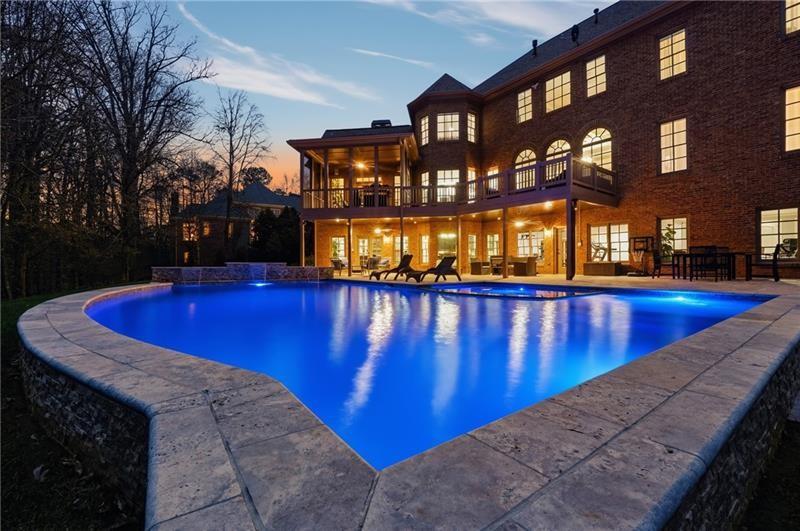 a view of a swimming pool with an outdoor space and seating area