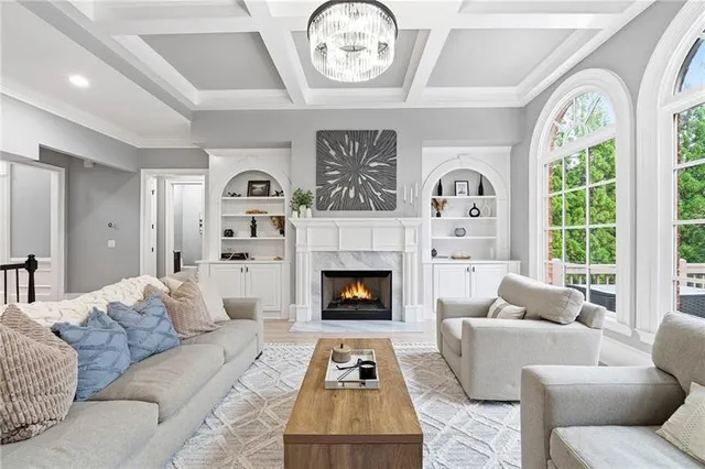 a open kitchen with stainless steel appliances granite countertop a stove a refrigerator a kitchen island a dining table and chairs with wooden floor