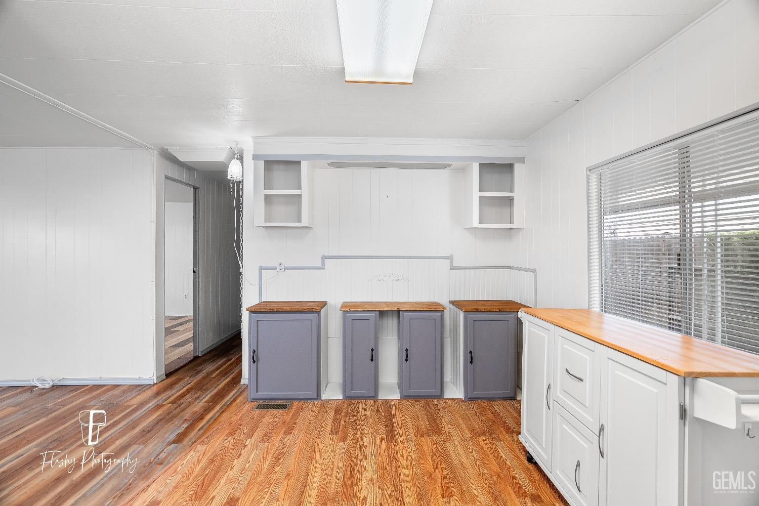 Undisclosed Address Bakersfield, CA 93301 - Photo 11 of 27 a kitchen with granite countertop a sink cabinets and wooden floor