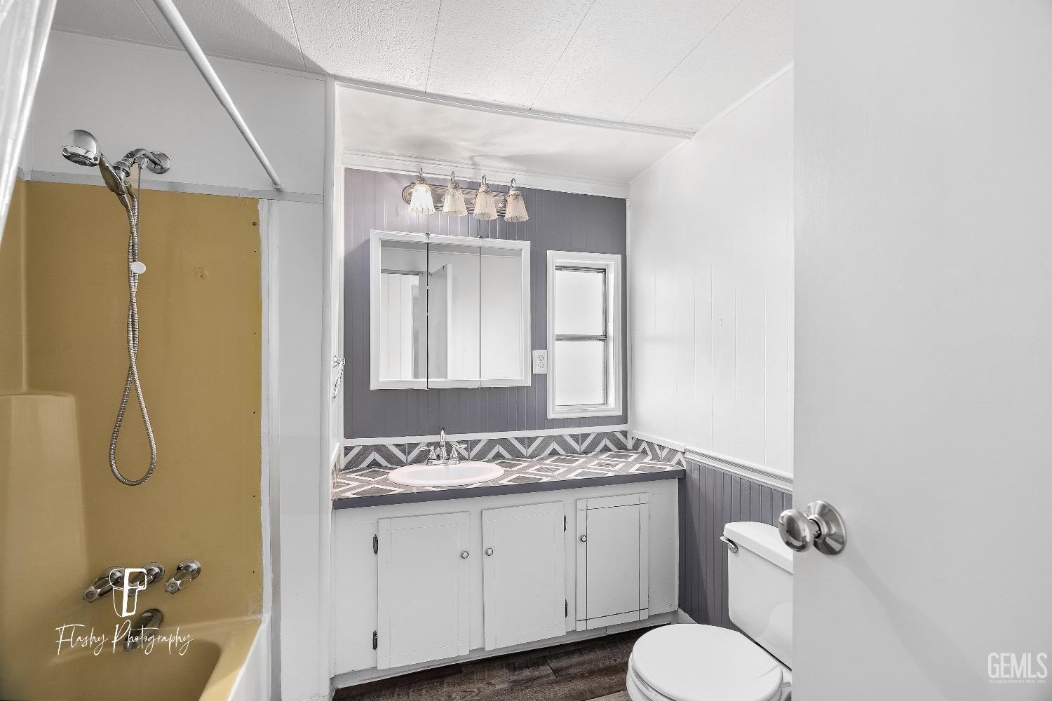 Undisclosed Address Bakersfield, CA 93301 - Photo 19 of 27 a bathroom with a granite countertop sink toilet and shower