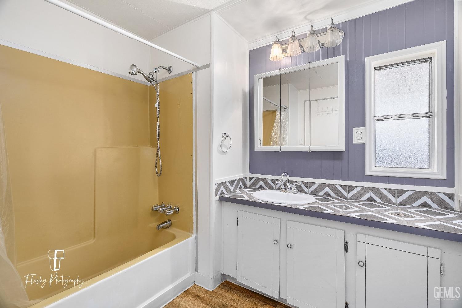 Undisclosed Address Bakersfield, CA 93301 - Photo 20 of 27 a bathroom with a granite countertop sink mirror and a bathtub