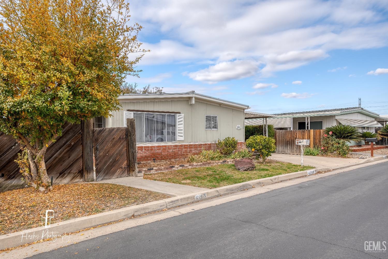 Undisclosed Address Bakersfield, CA 93301 - Photo 2 of 27 a front view of house with yard