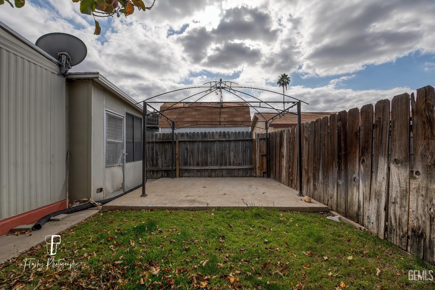 Undisclosed Address Bakersfield, CA 93301 - Photo 27 of 27 a view of backyard with small cabin and wooden fencing