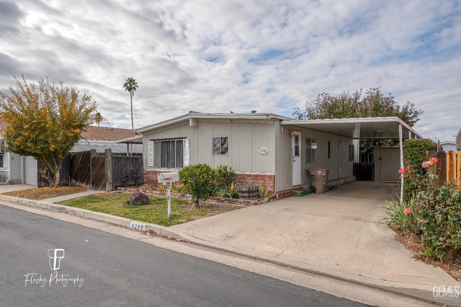 Undisclosed Address Bakersfield, CA 93301 - Photo 3 of 27 a view of a house with backyard and garden