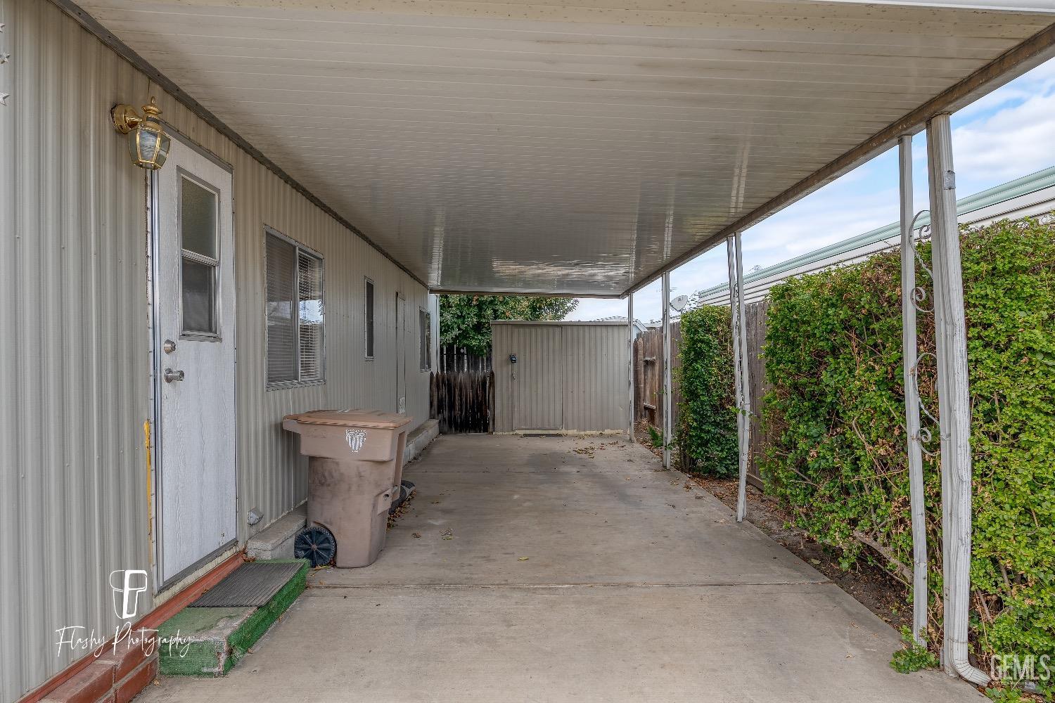 Undisclosed Address Bakersfield, CA 93301 - Photo 4 of 27 a view of a patio with table and chairs and wooden fence