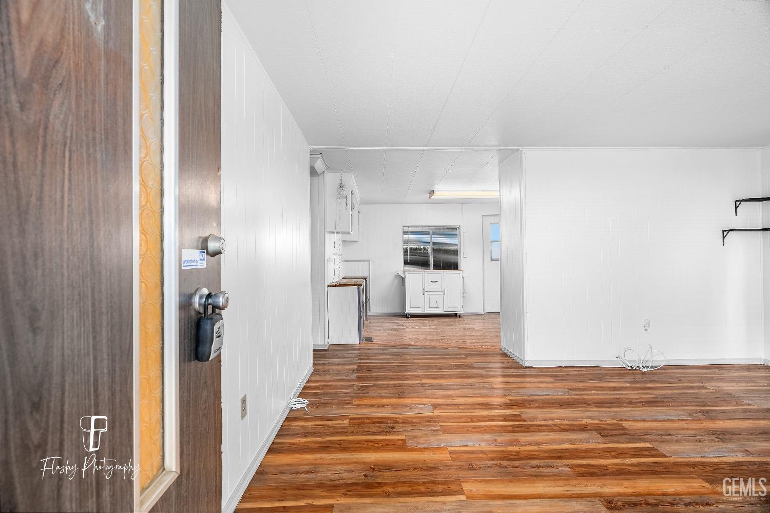 Undisclosed Address Bakersfield, CA 93301 - Photo 6 of 27 a view of a hallway with wooden floor and closet
